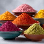 Vibrant collection of colorful powdered spices and natural food colorings in bowls