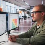 Man at computer reading reports