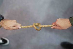 two hands pulling either side of a rope