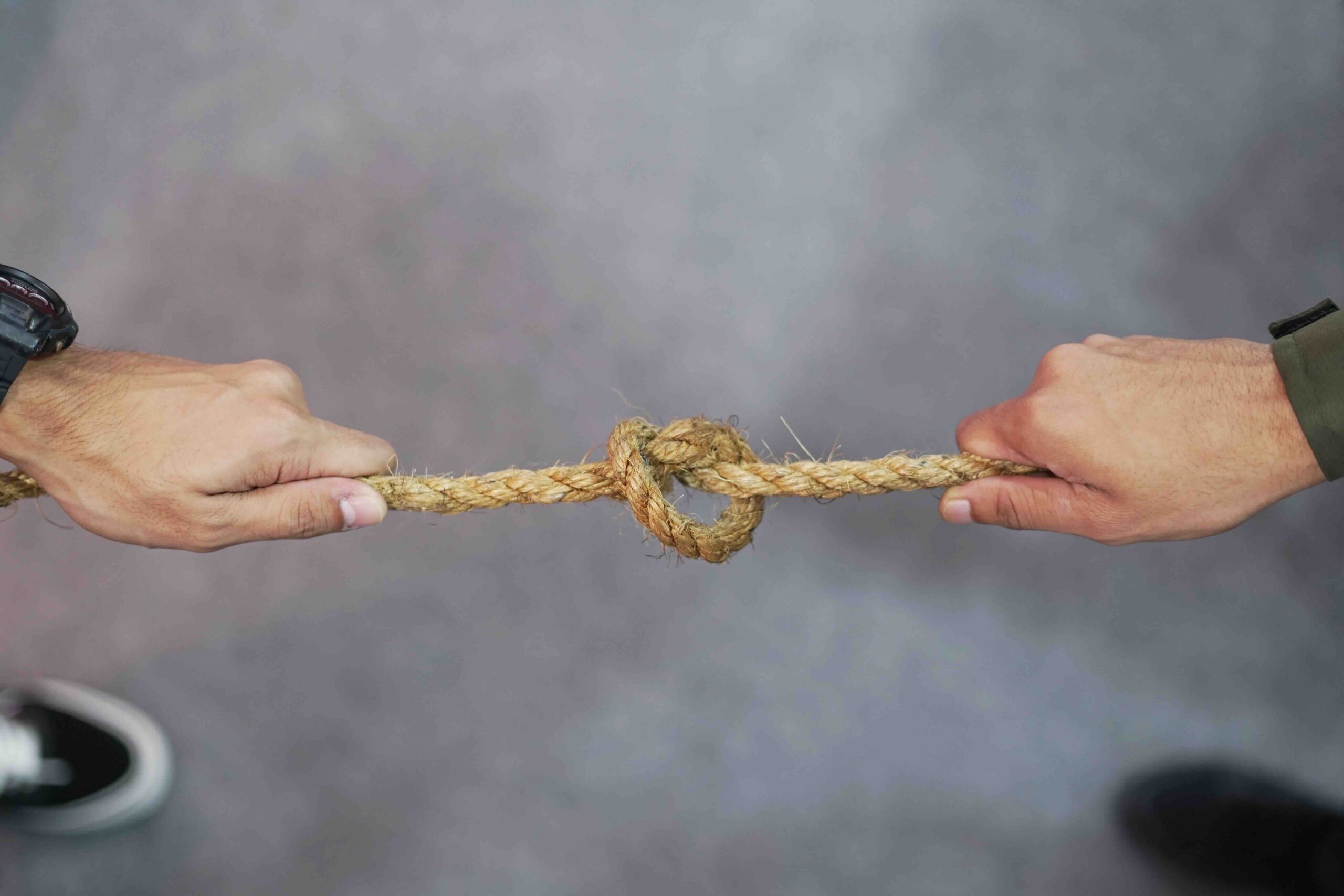 two hands pulling either side of a rope