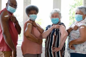 People rolling up their sleeves to get a vaccine