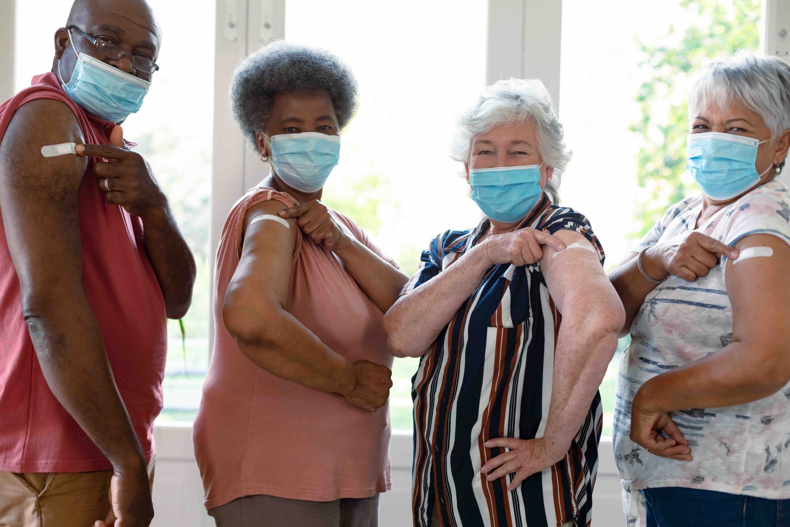 People rolling up their sleeves to get a vaccine