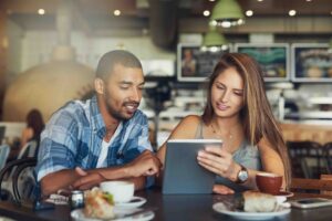 Two people looking at a tablet